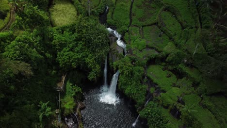 aerial view over air terjun kembar arum waterfall, tilt down shot, indonesia