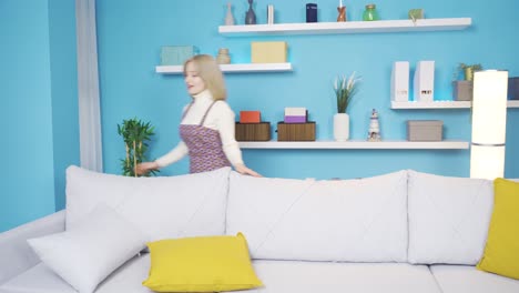 mujer feliz en casa limpiando la casa y mirándose en el espejo.