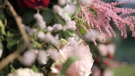 flower decoration on hexagon wedding arch by lake defocus closeup slow motion