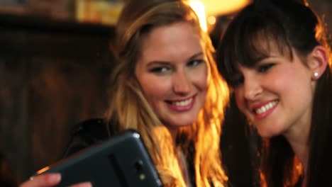Two-beautiful-women-taking-selfie-on-mobile-phone
