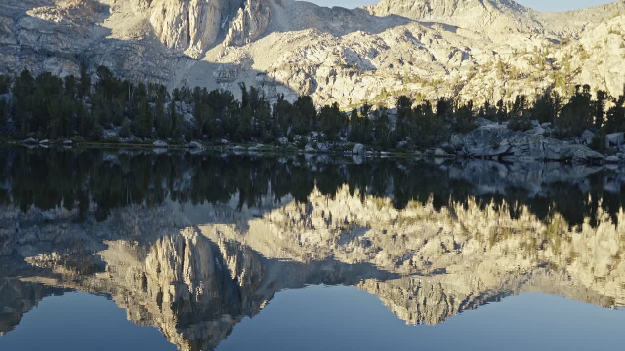 Clear mountain reflection on Rae Lakes with deep blue water along the John Muir Trail in California