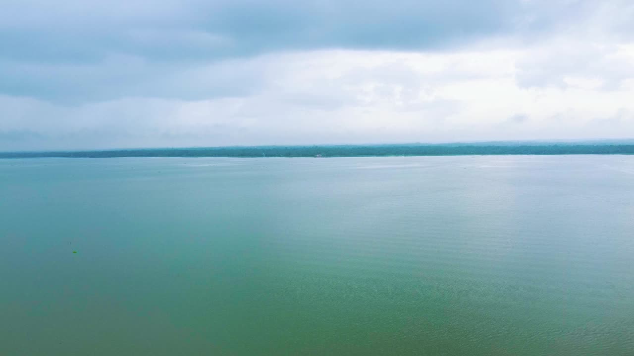 Morning view of a crystal clear lake and beautiful sky. A beautiful view of a still river, vembanadu lake Kerala.