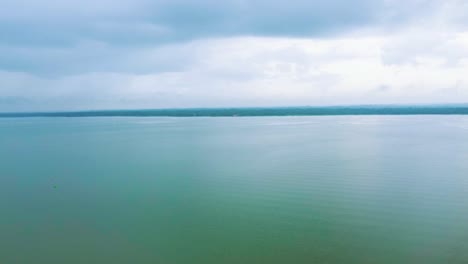 morning view of a crystal clear lake and beautiful sky. a beautiful view of a still river, vembanadu lake kerala.