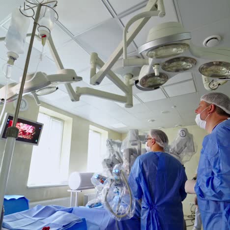 robotic arm for minimal invasive surgery. team of surgeons perform delicate operation using medical surgical robot