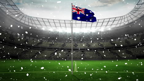 Animación-De-Confeti-Cayendo-Ondeando-La-Bandera-De-Australia-Contra-El-Estadio-Deportivo