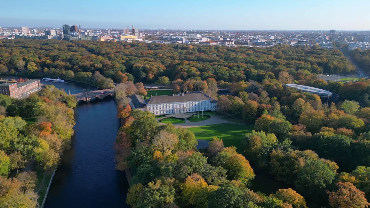 Schloss bellevue palace nestled among vibrant autumn foliage in tiergarten park, berlin, germany. Magic aerial view flight fly reverse drone