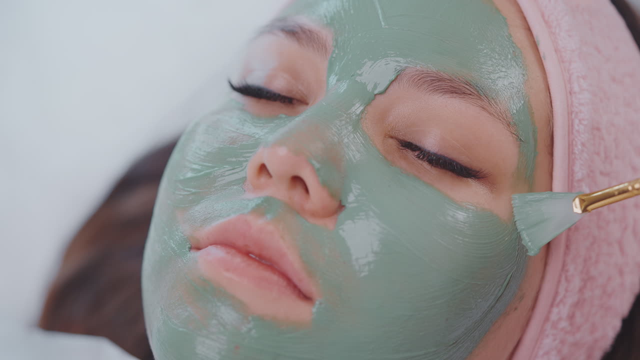 Woman receiving a facial mask treatment
