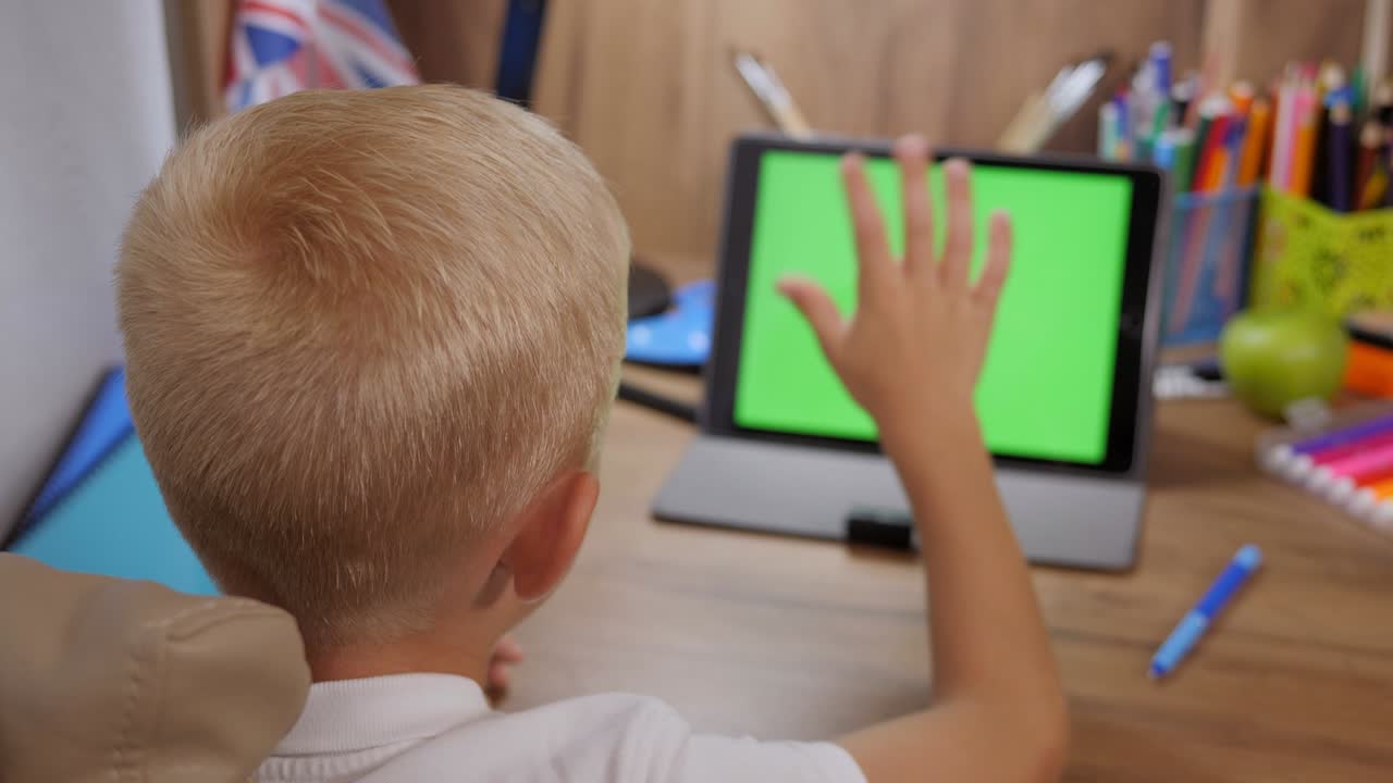 Preschool child boy distance online learning at home. Green screen ...