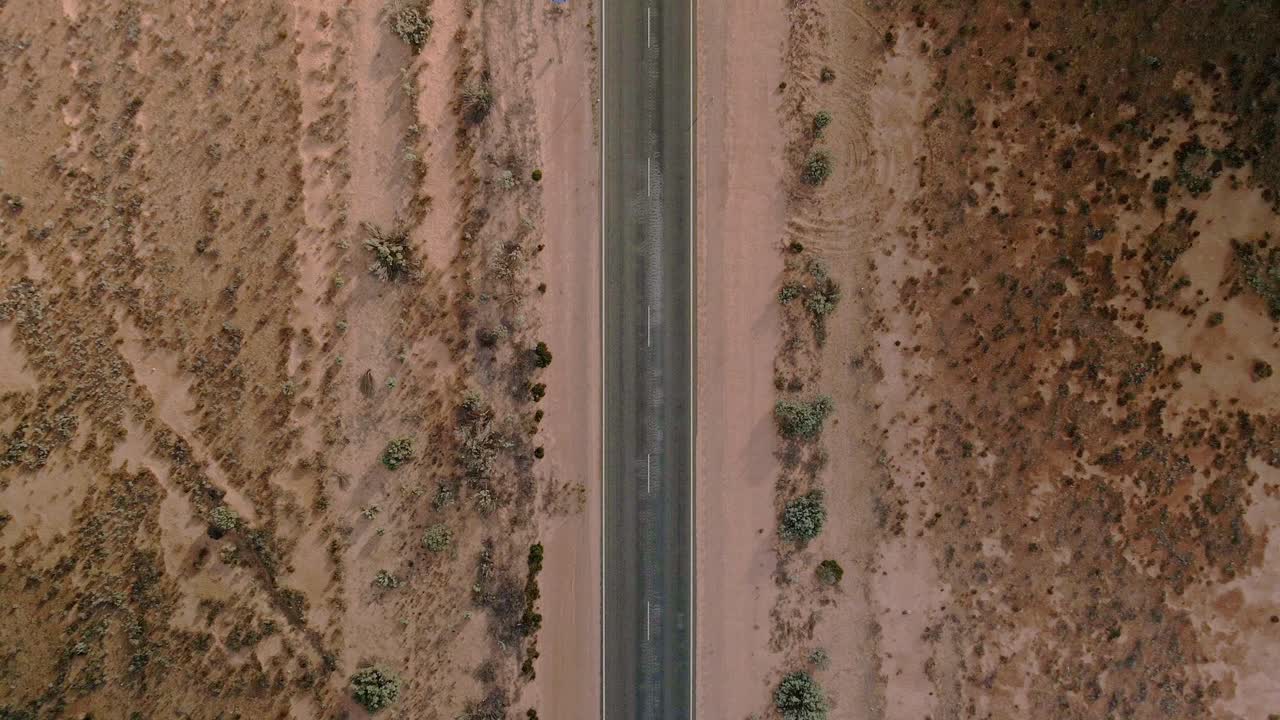 Aerial view above 90mile straight road, australia on a sunny, desert outback - cenital, drone shot