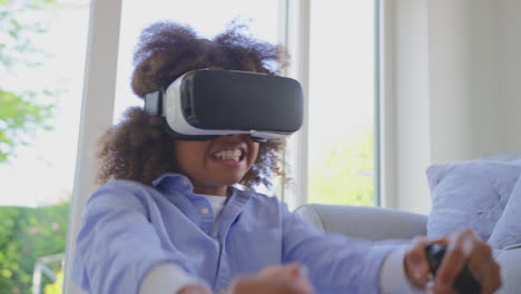 boy sitting on floor in lounge wearing vr headset playing driving computer game