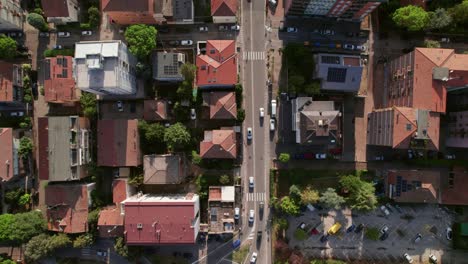 Ravenna,-Italy,-drone-top-down-going-forward-view-of-roundabout-with-cars-moving,-one-car-is-in-the-middle-of-the-frame