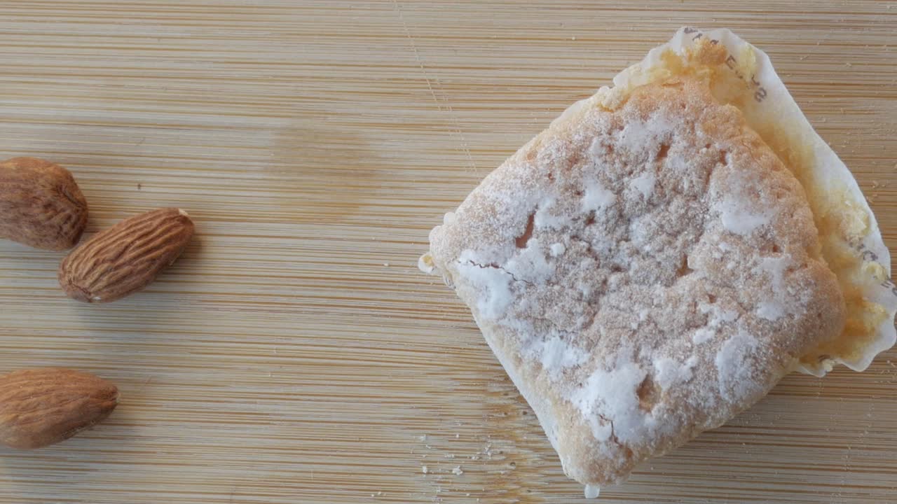 Close-up of almonds, glazed piece of cake and butter. Traditional from Spain during Christmas, Marquesitas Panning view.