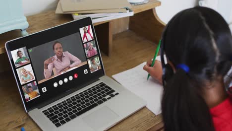 Composite-of-girl-using-laptop-for-online-lesson-at-home,-with-diverse-teacher-and-class-on-screen