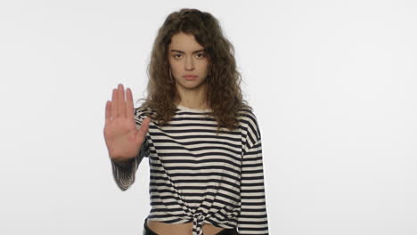 Young-woman-showing-stop-sign-on-white-background