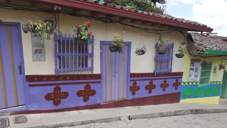 colorful, vibrant house facade with purple and yellow accents in guatapé, colombia, outdoor