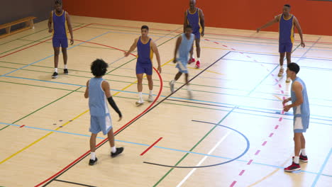 basketball players in gym practicing teamwork and strategy during game