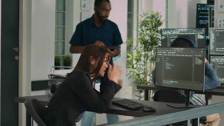 Software programer feeling stressed about writing code in front of computer