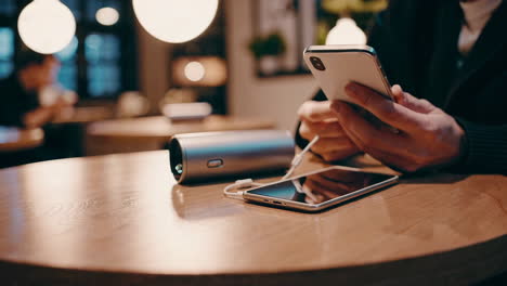 person using smartphones at a cafe