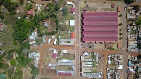 aerial view of the central market in moroto town, karamoja, uganda, showcasing bustling marketplace and surrounding residential area with various buildings and infrastructure, drone top down overhead