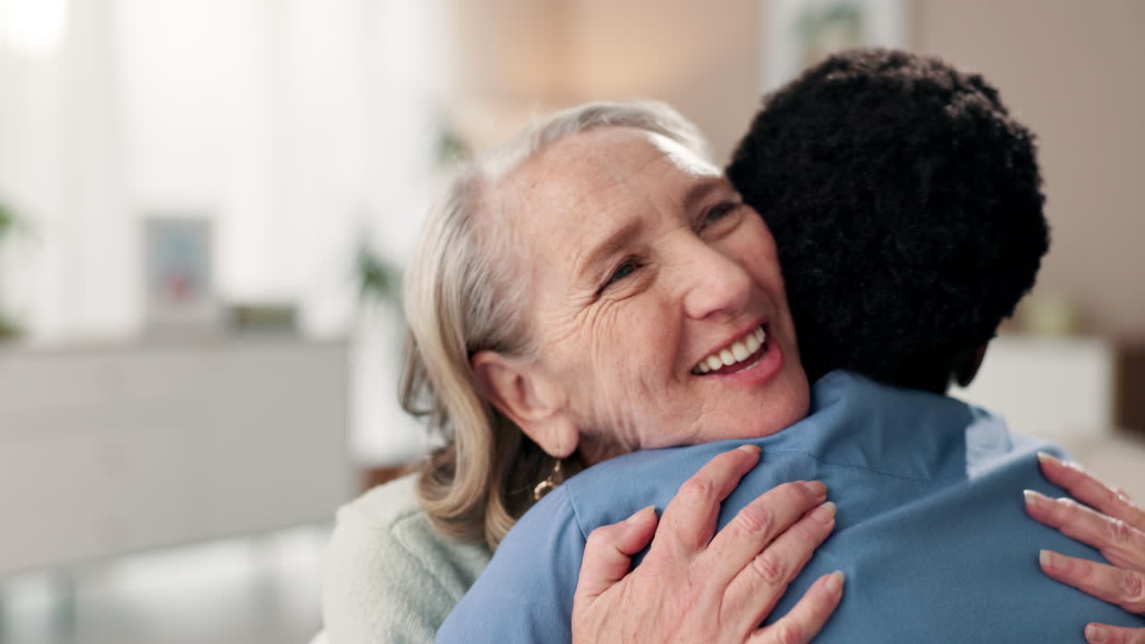 An elderly woman hugs a young man