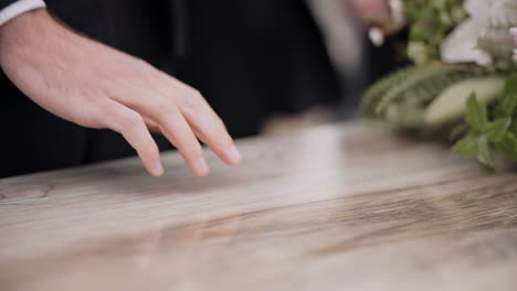 Death,-funeral-and-hand-of-man-on-coffin