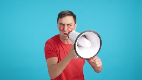 excited man with vietnamese flag on face using a megaphone