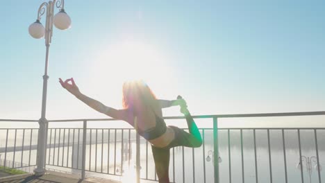 woman practicing yoga by the river
