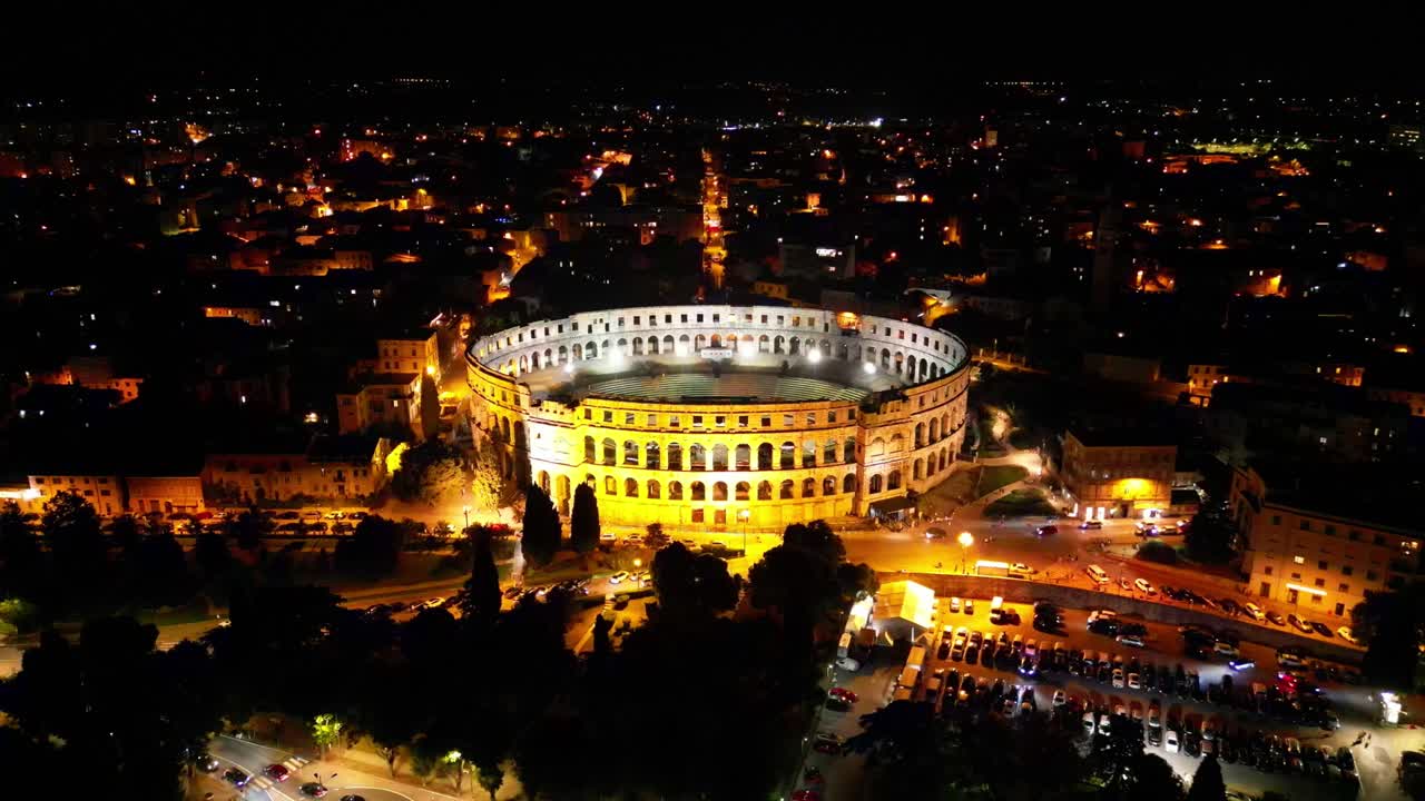 Breathtaking aerial panoramic at night of Pula Arena, Croatia, glowing with lights in the heart of the historic city