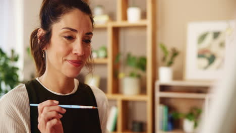 woman painting in a home interior