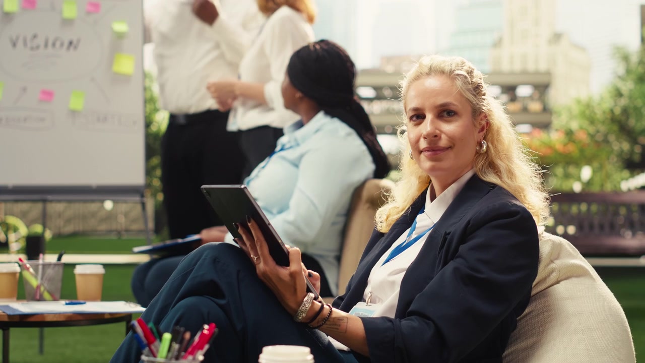 Businesswoman Using Tablet in Modern Collaborative Office Space