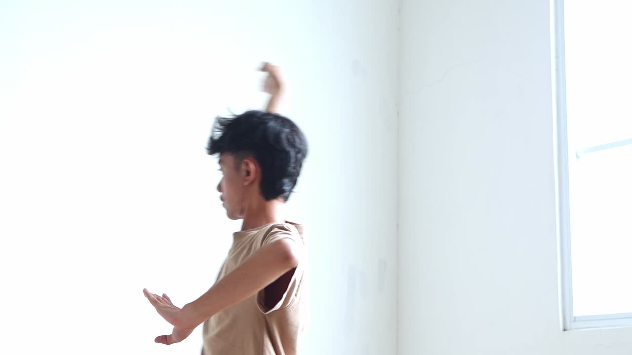 Person indoors wearing a t-shirt