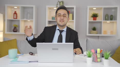 Home-office-worker-man-dances-looking-at-camera.