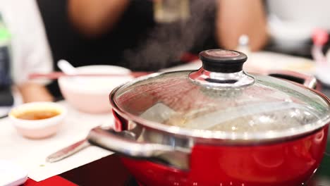 friends enjoying hotpot meal together in bangkok