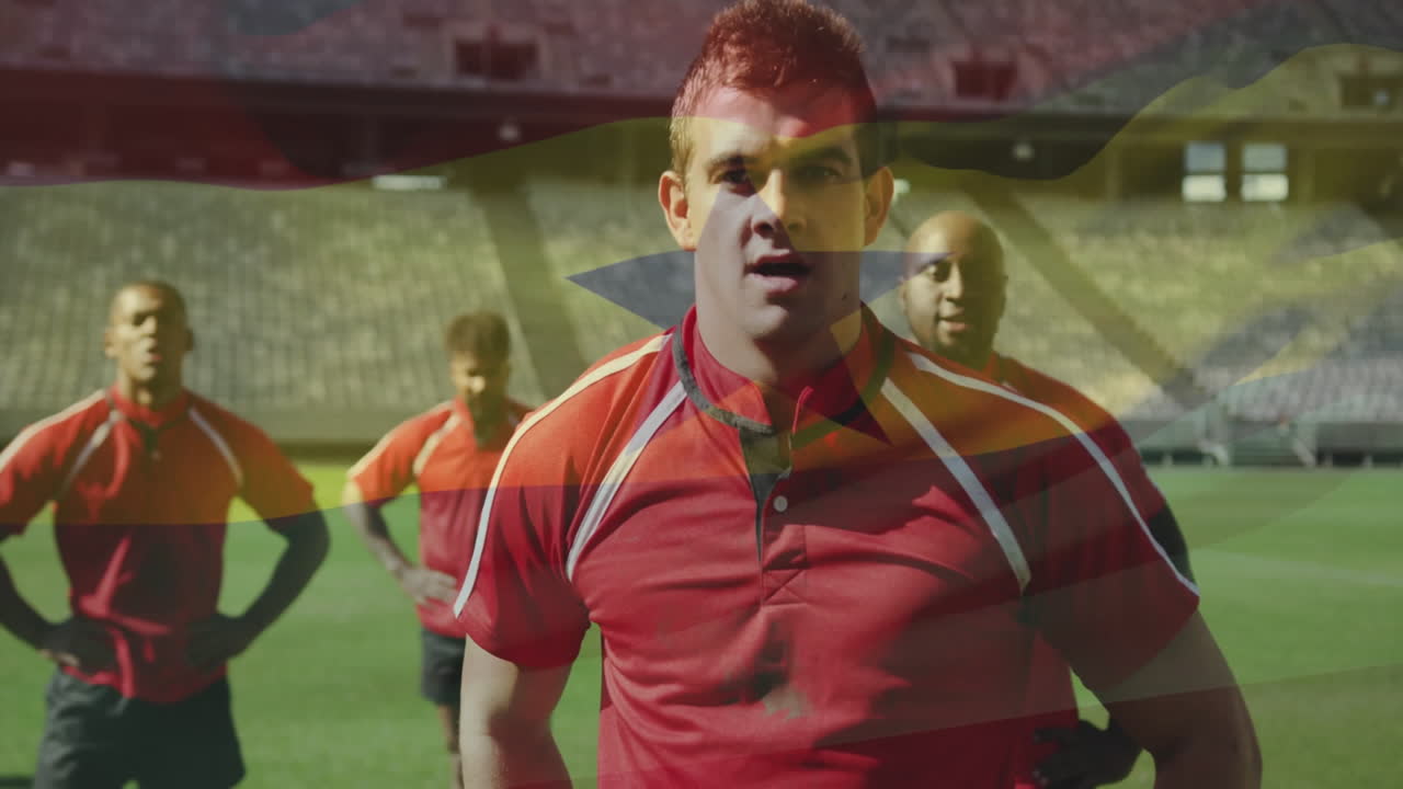 Rugby players in red jerseys standing on field with flag overlay animation