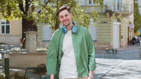 Man-tourist-smiling-friendly-at-camera-waving-hands-gesturing-invitation-hello-hi-greeting-goodbye