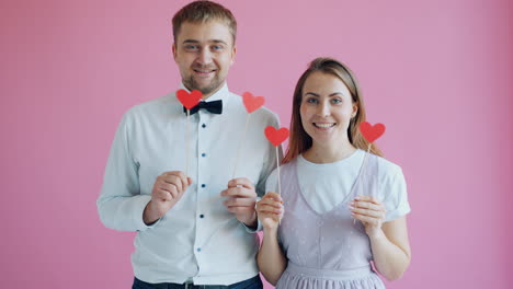 happy couple holding hearts