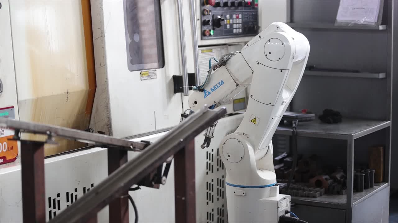 close - up view robotic arm operating load and unload Components PART