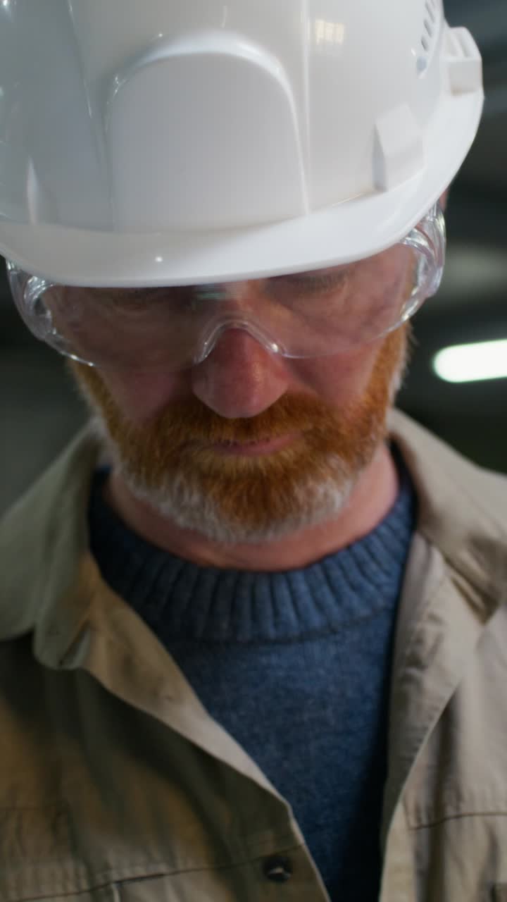 Man using tablet and hard hat