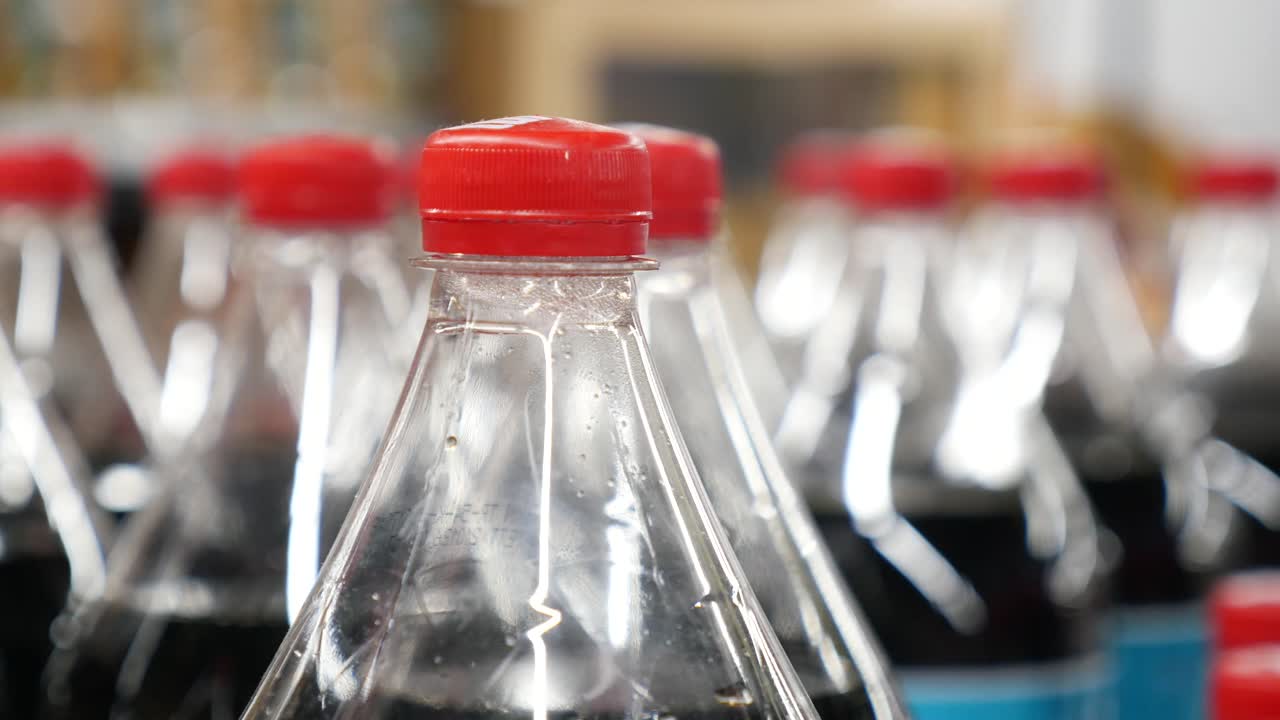 Rows of Soda Bottles with Red Caps