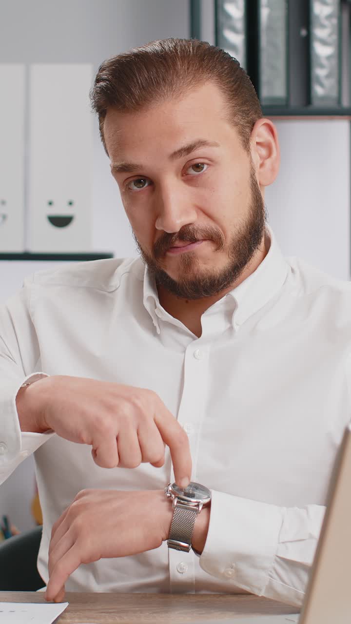 Business man showing time on wrist watch clock approve pointing finger time to start work deadline