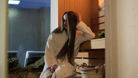 young woman having rest in sauna alone