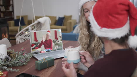 Happy-diverse-couple-and-male-friend-having-christmas-laptop-video-call,-slow-motion