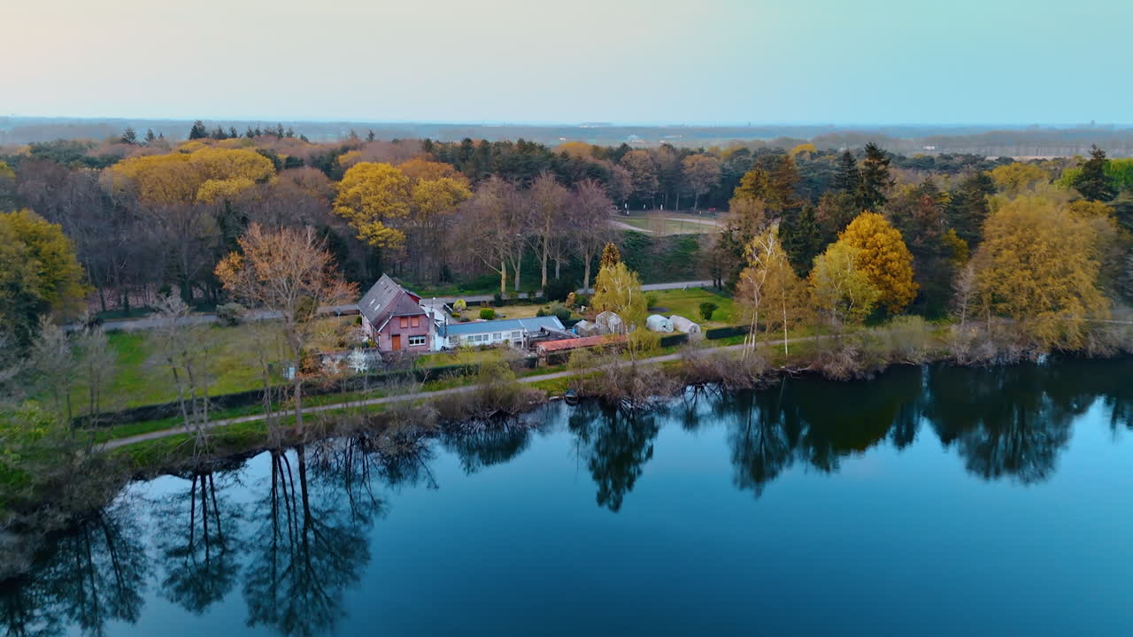 Autumn lake calm in Netherlands. A serene aerial view captures a tranquil lake surrounded by autumn foliage and trees in the Netherlands