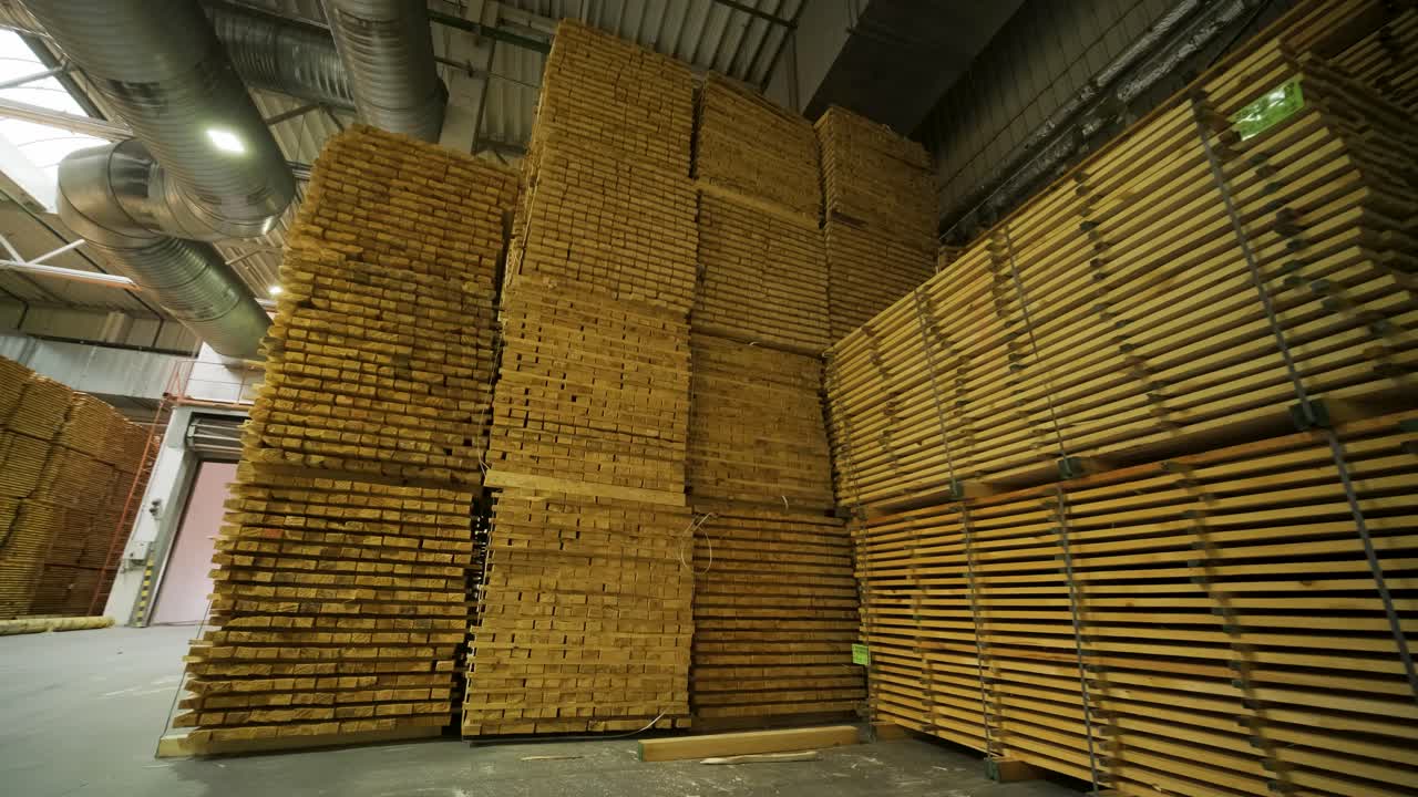 Large Stacks of Wooden Planks in Industrial Warehouse