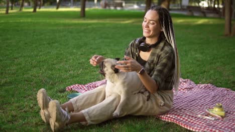 Attractive-Woman-Holds-A-Little-Pug-On-Her-Knees-It-Actively-Whirls-And-Tries-To-Bite-Gently