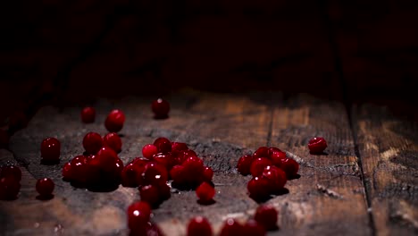 red cranberries on a wooden surface