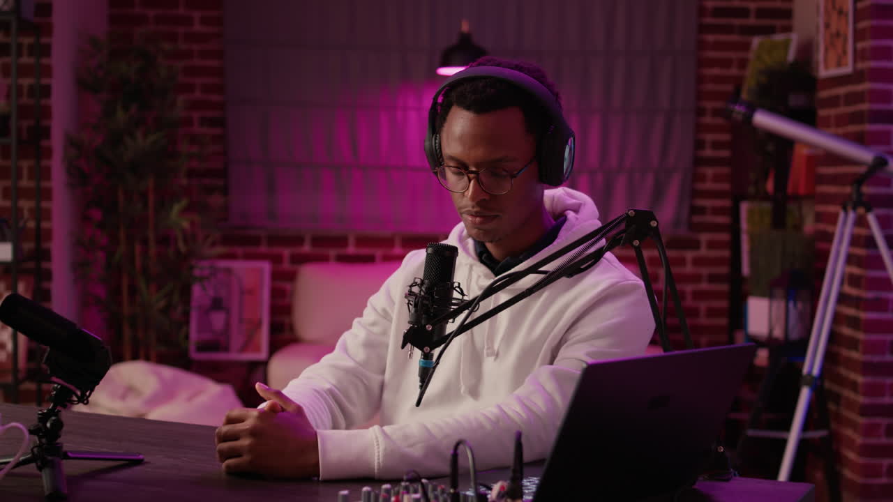 African american podcaster greeting guest doing fist bump hand gesture while recording podcast using digital video camera