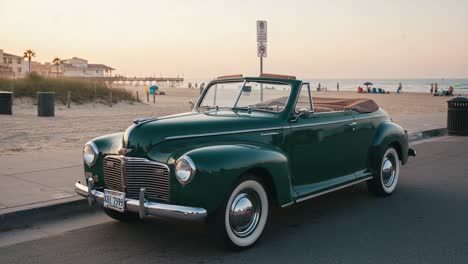 classic green convertible parked on beachfront road during sunset, showcasing timeless design and nostalgic charm of vintage automobiles