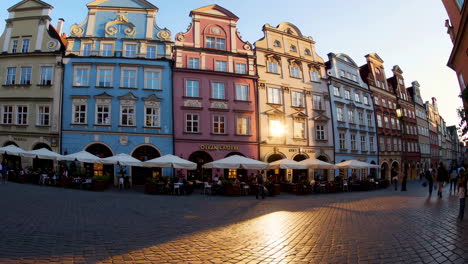 vibrant historic buildings and outdoor cafes in a european city square at sunset