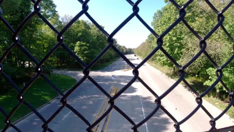 Cars-on-busy-road-with-exit-from-bridge-with-chain-link---USA